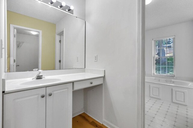 433 Den Ridge Dr, Walhalla, SC 29691 - bathroom with a textured ceiling, vanity, and a bath