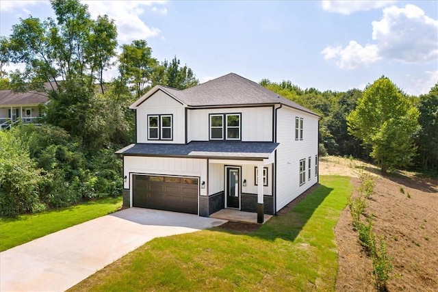 123 Moore Dr, Easley, SC 29642 - view of front of house featuring concrete driveway, a garage, a front lawn, board and batten siding, and a shingled roof