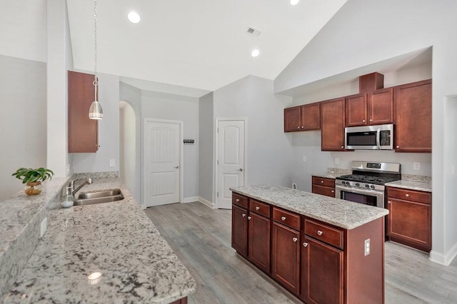 618 Motor Boat Way, Seneca, SC 29672 - kitchen featuring stainless steel appliances, arched walkways, light wood-style floors, light stone counters, and high vaulted ceiling