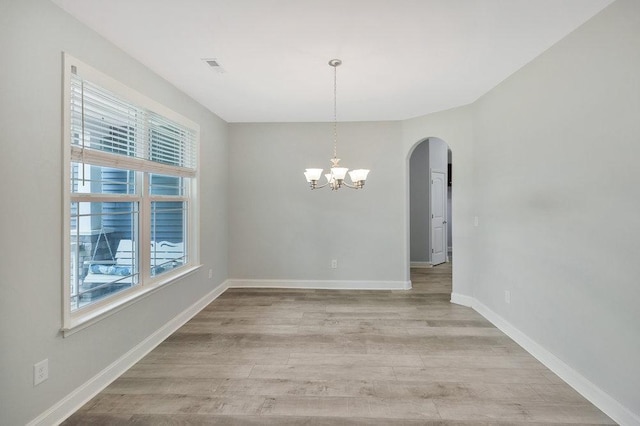 618 Motor Boat Way, Seneca, SC 29672 - unfurnished dining area with plenty of natural light, arched walkways, light wood-style flooring, and a chandelier