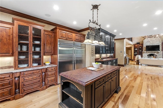 264 Featherstone Dr, Sunset, SC 29685 - kitchen with stainless steel built in refrigerator, light wood finished floors, ornamental molding, glass insert cabinets, and open shelves