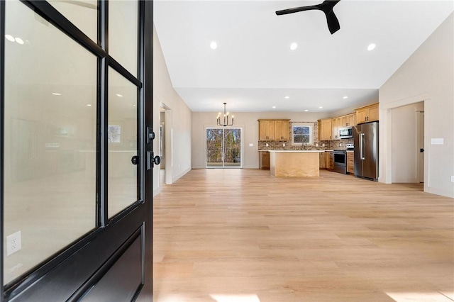 333 Ravens View Dr, Seneca, SC 29678 - kitchen with stainless steel appliances, decorative backsplash, a chandelier, light wood-style floors, and ceiling fan