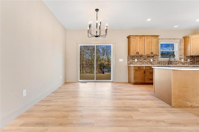 333 Ravens View Dr, Seneca, SC 29678 - kitchen with a chandelier, light wood-style flooring, decorative backsplash, light countertops, and recessed lighting