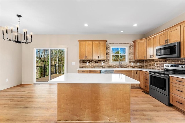 333 Ravens View Dr, Seneca, SC 29678 - kitchen featuring stainless steel appliances, light wood-style flooring, a kitchen island, decorative backsplash, and recessed lighting