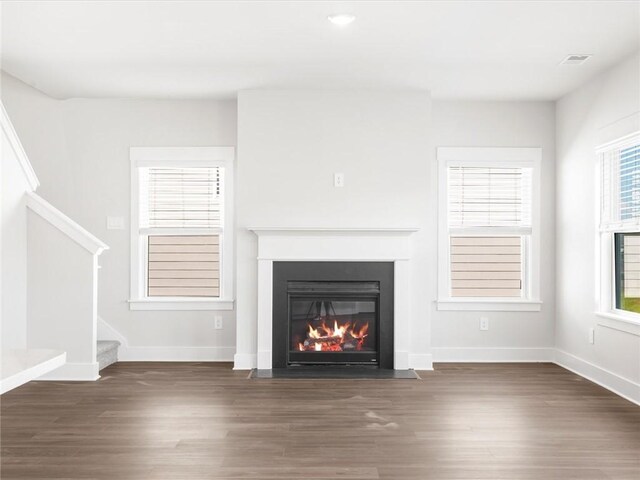 791 Burghley Cir, Greer, SC 29651 - unfurnished living room featuring a fireplace with flush hearth, stairs, and wood finished floors