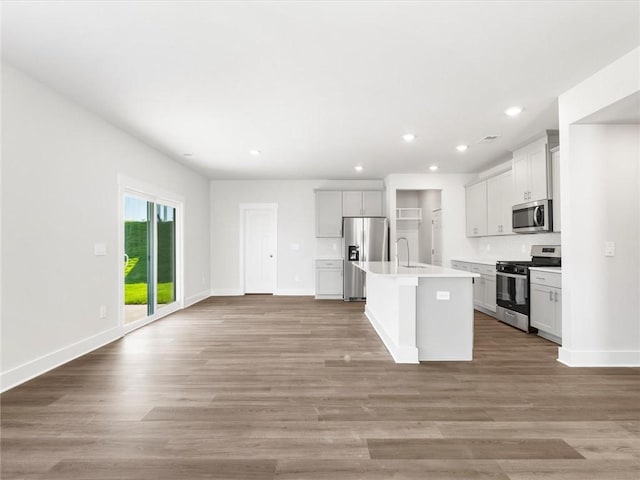 791 Burghley Cir, Greer, SC 29651 - kitchen with stainless steel appliances, a center island with sink, recessed lighting, open floor plan, and light countertops