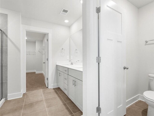 791 Burghley Cir, Greer, SC 29651 - bathroom with a shower stall, tile patterned floors, double vanity, a spacious closet, and recessed lighting