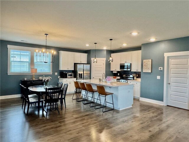 104 Laurel Oak Dr, Anderson, SC 29621 - kitchen featuring stainless steel appliances, a kitchen island with sink, white cabinetry, recessed lighting, and dark wood-type flooring