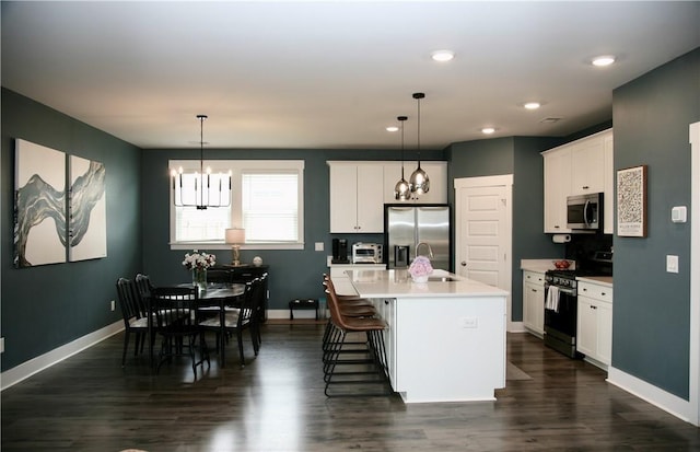 104 Laurel Oak Dr, Anderson, SC 29621 - kitchen featuring appliances with stainless steel finishes, a chandelier, dark wood-style floors, white cabinetry, and recessed lighting