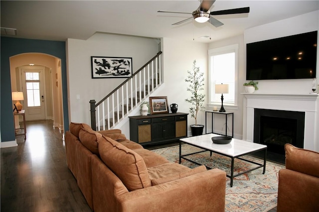 104 Laurel Oak Dr, Anderson, SC 29621 - living room with arched walkways, a ceiling fan, wood finished floors, stairway, and a fireplace with flush hearth