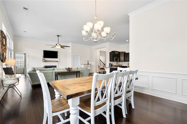 100 Dartford Ct, Easley, SC 29642 - dining room with dark wood-style floors, a chandelier, ceiling fan, a fireplace, and crown molding