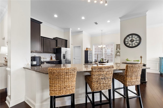 100 Dartford Ct, Easley, SC 29642 - kitchen with stainless steel fridge, stone counters, decorative backsplash, a chandelier, and recessed lighting