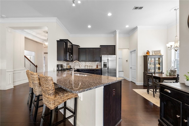 100 Dartford Ct, Easley, SC 29642 - kitchen featuring stainless steel fridge with ice dispenser, dark stone countertops, a breakfast bar area, a peninsula, and dark wood-style floors