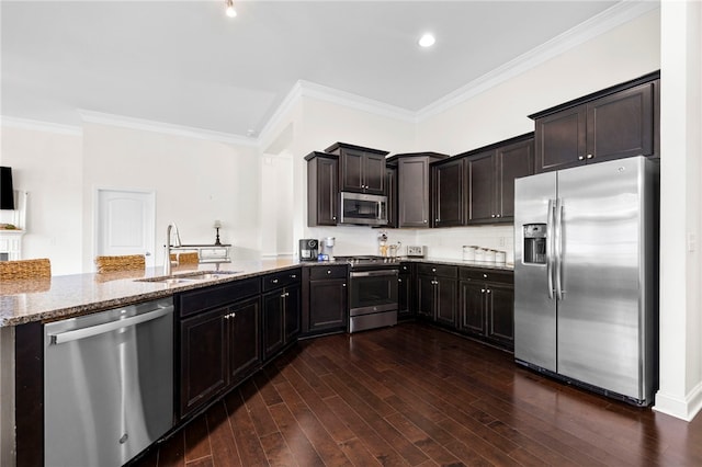 100 Dartford Ct, Easley, SC 29642 - kitchen with stainless steel appliances, light stone countertops, crown molding, dark wood finished floors, and a peninsula