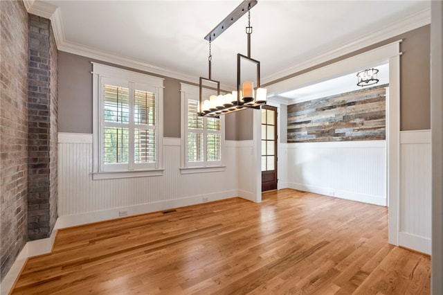 1219 Old Mill Rd, Easley, SC 29642 - unfurnished dining area featuring a chandelier, wainscoting, light wood-style floors, and crown molding