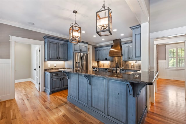 1219 Old Mill Rd, Easley, SC 29642 - kitchen featuring stainless steel fridge, custom range hood, a kitchen breakfast bar, light wood-type flooring, and a wainscoted wall
