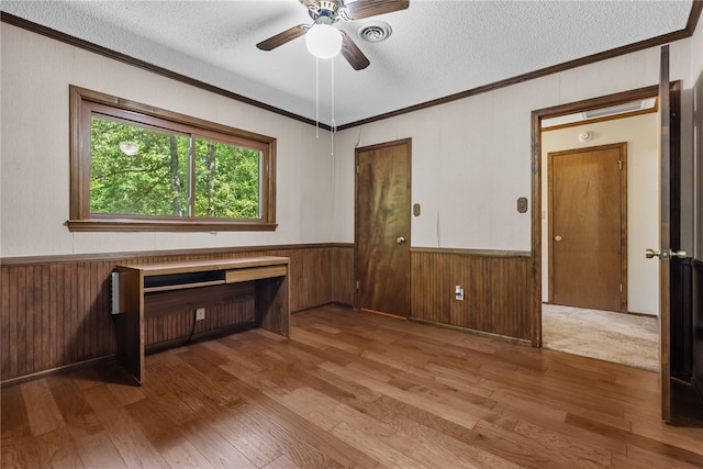 320 Whitfield Dr, Pendleton, SC 29670 - spare room with a textured ceiling, wood-type flooring, crown molding, ceiling fan, and a wainscoted wall