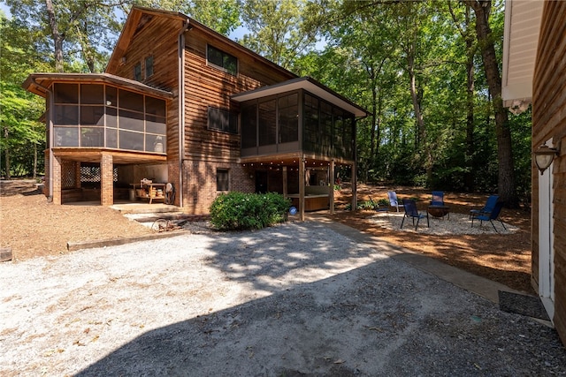 320 Whitfield Dr, Pendleton, SC 29670 - rear view of property with a sunroom, a patio, and a fire pit