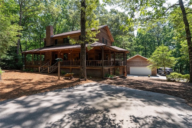 320 Whitfield Dr, Pendleton, SC 29670 - rustic home with covered porch, a garage, a chimney, and an outbuilding