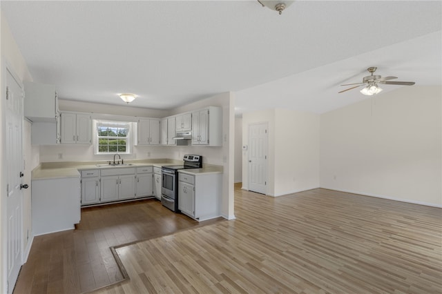 1330 Grove Rd, Anderson, SC 29621 - kitchen with stainless steel electric stove, wood finished floors, under cabinet range hood, light countertops, and a ceiling fan
