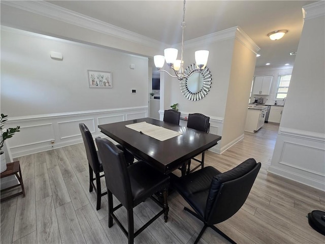 406 Willow Grove Way, Anderson, SC 29621 - dining space with a chandelier, ornamental molding, wainscoting, light wood-style floors, and a decorative wall
