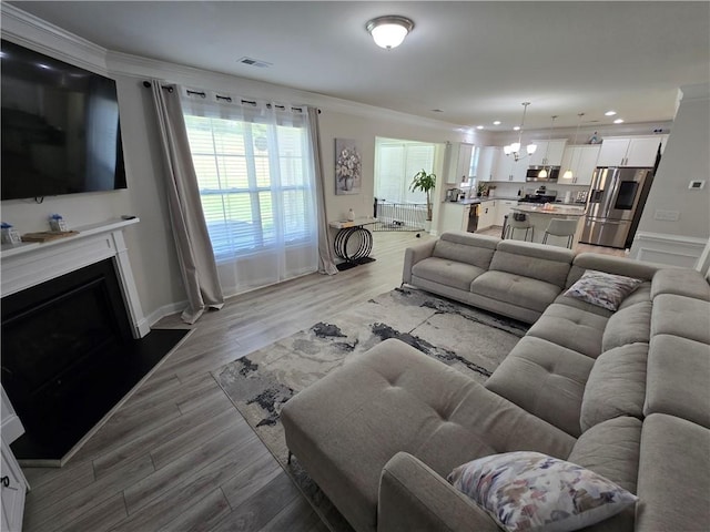 406 Willow Grove Way, Anderson, SC 29621 - living area with a fireplace, ornamental molding, light wood-style floors, a chandelier, and recessed lighting