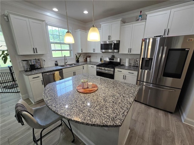 406 Willow Grove Way, Anderson, SC 29621 - kitchen with stainless steel appliances, a center island, white cabinets, ornamental molding, and a breakfast bar area