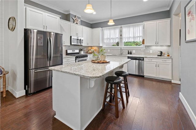 245 Thomas Green Blvd, Clemson, SC 29631 - kitchen with stainless steel appliances, white cabinets, ornamental molding, a kitchen breakfast bar, and a center island