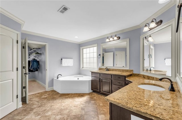 911 Devenger Rd, Greer, SC 29650 - bathroom featuring ornamental molding, two vanities, a bath, and a walk in closet