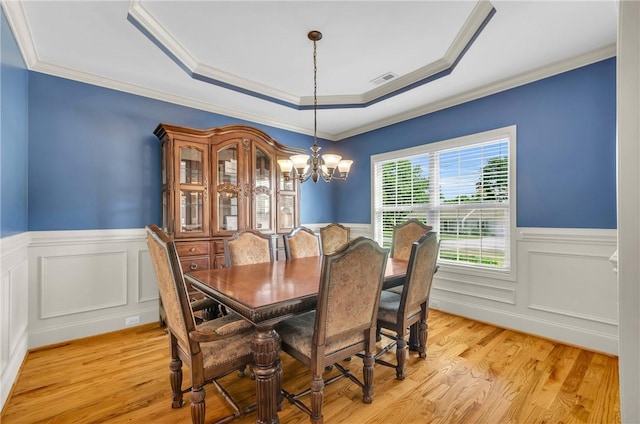 911 Devenger Rd, Greer, SC 29650 - dining space featuring wainscoting, a chandelier, a raised ceiling, light wood-style floors, and crown molding