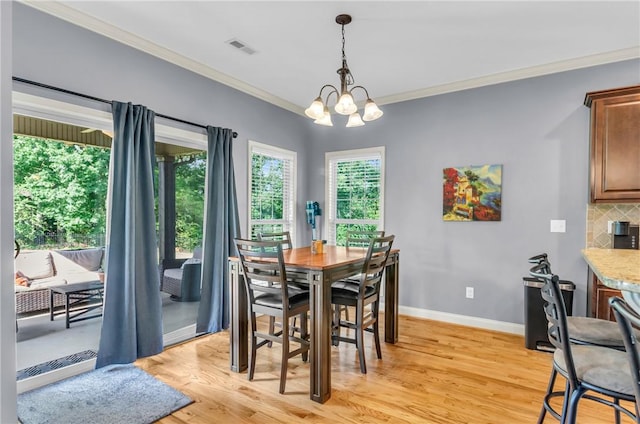 911 Devenger Rd, Greer, SC 29650 - dining area with ornamental molding, light wood-type flooring, and a chandelier