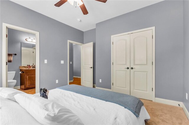 911 Devenger Rd, Greer, SC 29650 - bedroom featuring a closet, ceiling fan, ensuite bath, and light colored carpet