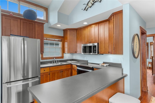 1230 Melton Rd # 64, West Union, SC 29696 - kitchen featuring appliances with stainless steel finishes, brown cabinetry, a kitchen breakfast bar, wood finished floors, and recessed lighting