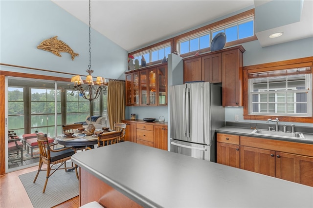 1230 Melton Rd # 64, West Union, SC 29696 - kitchen with freestanding refrigerator, a high ceiling, brown cabinetry, glass insert cabinets, and a chandelier