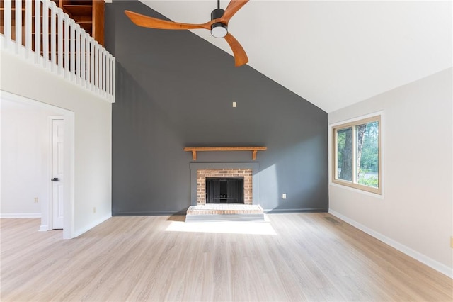 913 Berkeley Dr, Clemson, SC 29631 - unfurnished living room featuring high vaulted ceiling, a brick fireplace, a ceiling fan, and wood finished floors