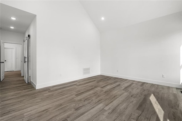 114 Hillcrest Cir, Anderson, SC 29624 - spare room with wood finished floors, recessed lighting, vaulted ceiling, and a barn door
