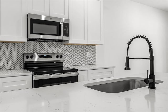 114 Hillcrest Cir, Anderson, SC 29624 - kitchen with appliances with stainless steel finishes, white cabinets, and tasteful backsplash