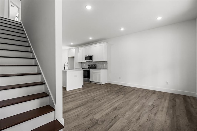 114 Hillcrest Cir, Anderson, SC 29624 - unfurnished living room featuring wood finished floors, stairway, and recessed lighting