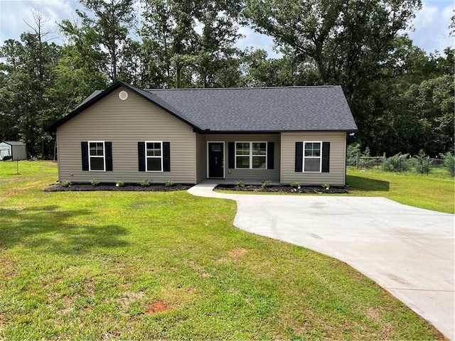 412 Leatherdale Rd, Iva, SC 29655 - view of front of home with a front yard, a shed, roof with shingles, and concrete driveway