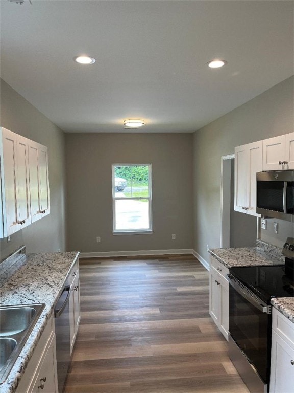 412 Leatherdale Rd, Iva, SC 29655 - kitchen with stainless steel appliances, white cabinets, recessed lighting, wood finished floors, and light stone counters