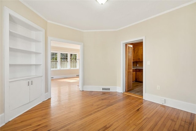 23 Gilmer Dr, Anderson, SC 29621 - empty room with light wood-type flooring, crown molding, and built in shelves