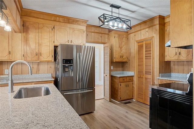 23 Gilmer Dr, Anderson, SC 29621 - kitchen with stainless steel refrigerator with ice dispenser, wood walls, light wood-style floors, hanging light fixtures, and light stone counters