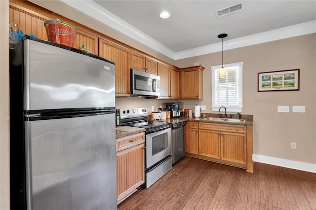 101 W Ln Unit 1000, Clemson, SC 29631 - kitchen featuring appliances with stainless steel finishes, crown molding, dark wood finished floors, hanging light fixtures, and dark countertops