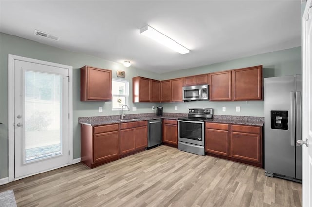 131 Colonial Walk, Pickens, SC 29671 - kitchen with stainless steel appliances, light wood-style flooring, and brown cabinetry