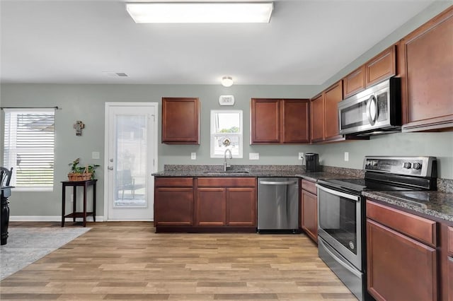 131 Colonial Walk, Pickens, SC 29671 - kitchen with appliances with stainless steel finishes, light wood-style flooring, and dark stone countertops