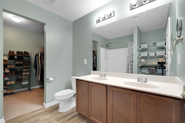 131 Colonial Walk, Pickens, SC 29671 - full bathroom with wood finished floors, double vanity, a shower with shower curtain, and a walk in closet