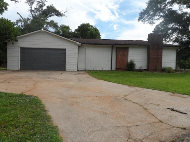 6005 Kaye St, Seneca, SC 29678 - view of front of house featuring a garage, a front lawn, and a chimney