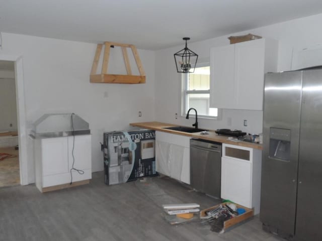 6005 Kaye St, Seneca, SC 29678 - kitchen featuring appliances with stainless steel finishes, white cabinetry, wood finished floors, and wooden counters