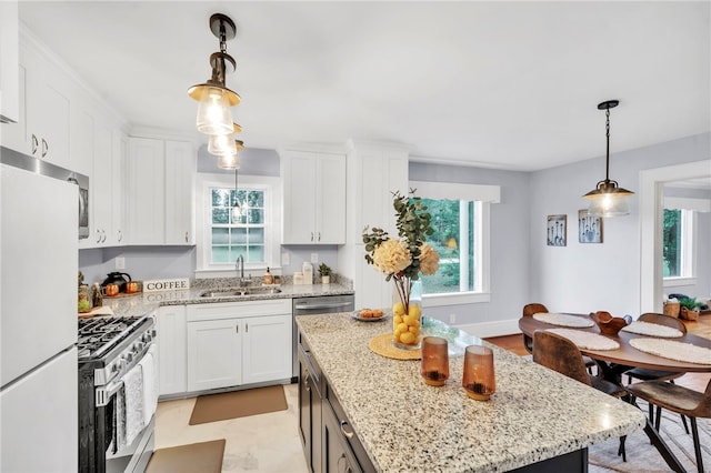 513 Shiloh Rd, Seneca, SC 29678 - kitchen featuring stainless steel appliances, white cabinets, hanging light fixtures, and light stone counters