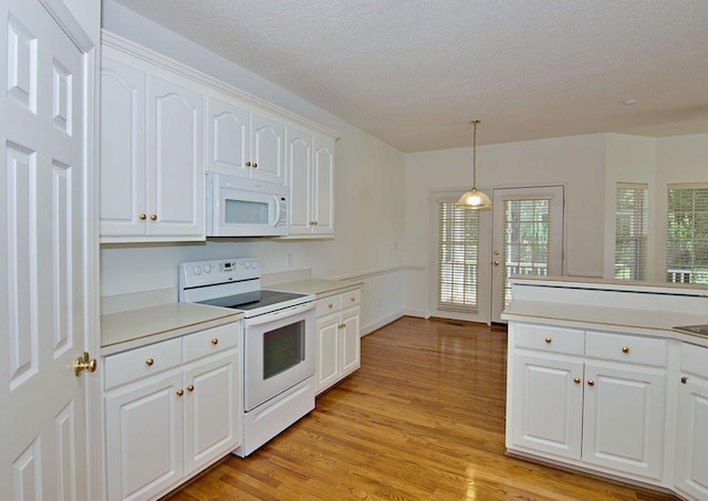 200 Smithfield Dr, Anderson, SC 29621 - kitchen featuring white appliances, light wood-type flooring, white cabinets, hanging light fixtures, and light countertops